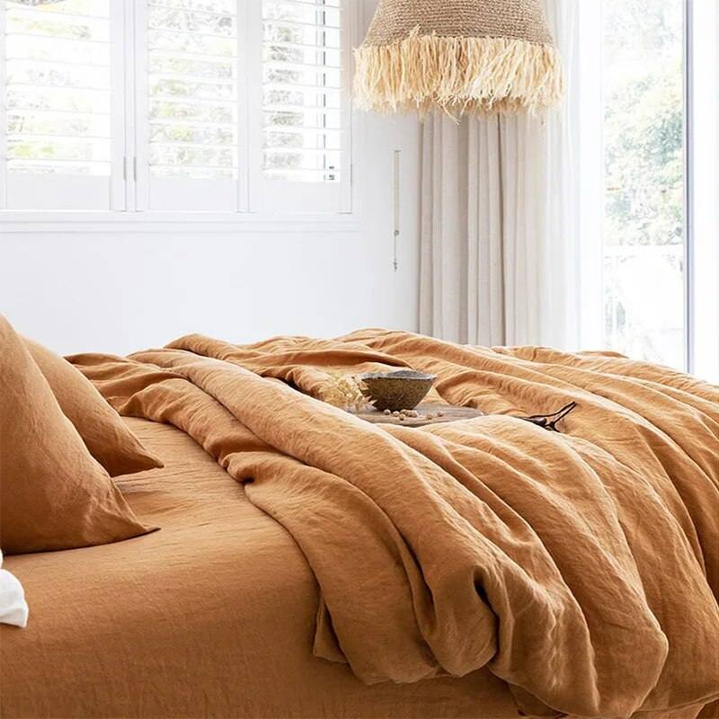 milk apricot color 100% french linen duvet cover set with two matching pillows in a well lit white room - Fluffyslip