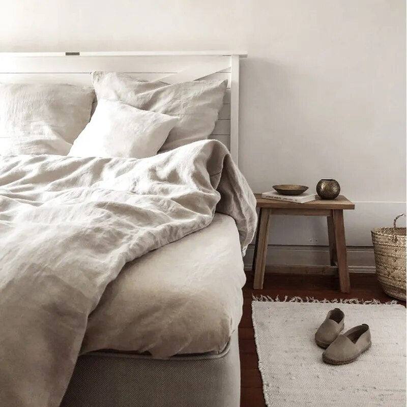Natural color 100% french linen duvet cover set with two matching pillows in a room with white walls- Fluffyslip