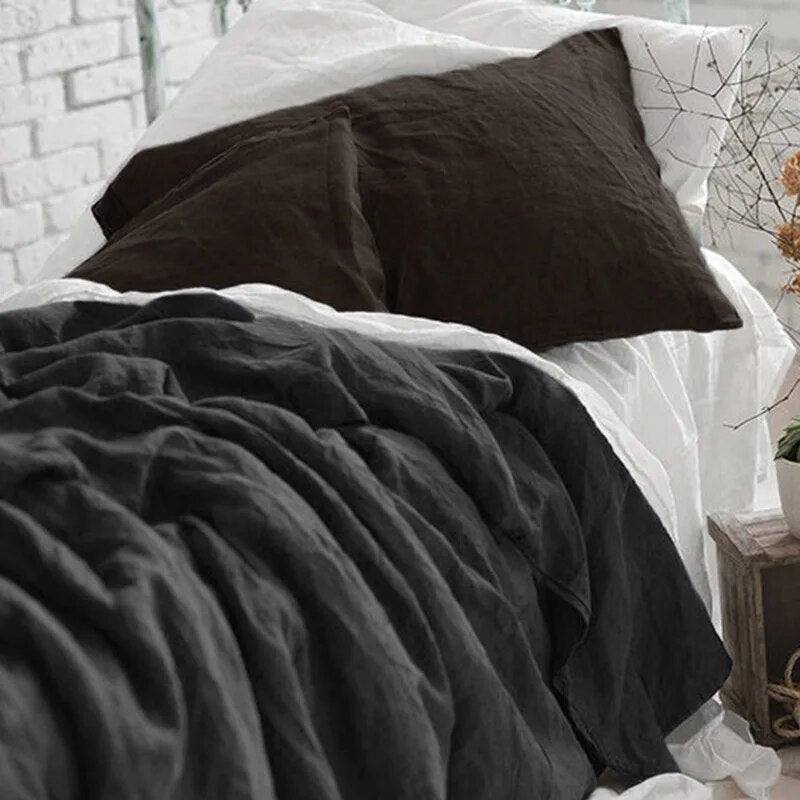 Carbon color 100% french linen duvet cover set with two matching pillows in a white room - Fluffyslip