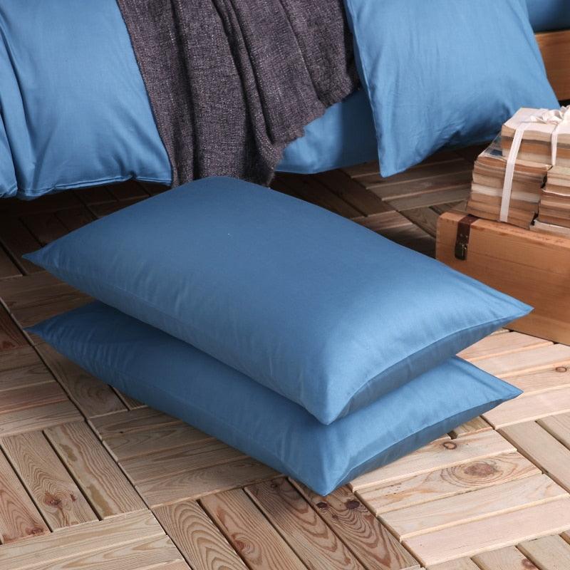 100% Cotton blue pillowcases on the floor next to the 100% blue Duvet Cover Set - Fluffyslip
