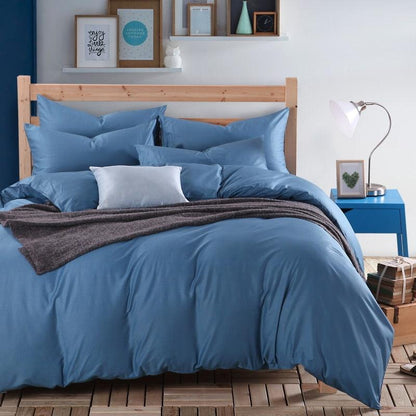 Front view of a 100% Cotton Duvet Cover Set in the color blue with matching blue pillowcases in a full bedroom setup - Fluffyslip