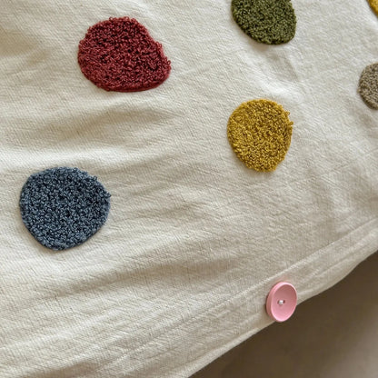 Textured multicolor polka dot duvet cover with pink button on cream cotton fabric