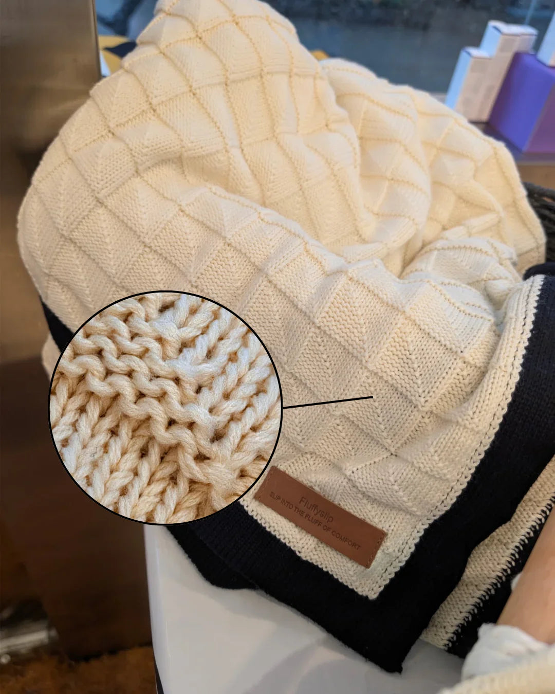 close up of woven pattern cream black luxury cotton blanket