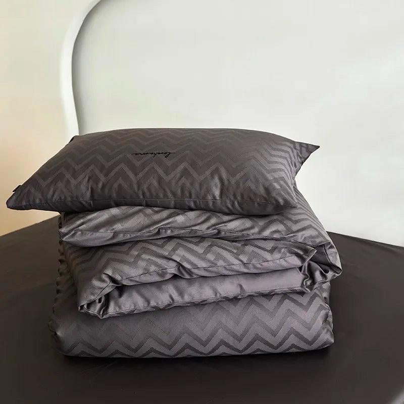 600TC Egyptian Cotton Diamond Wave Pattern Duvet Set in black folded and displayed on top of an egyptian cotton flat sheet - Fluffyslip - Fluffyslip
