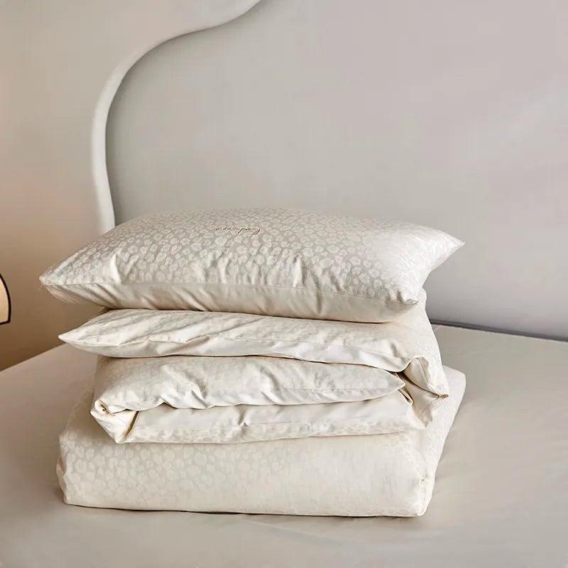 600TC Egyptian Cotton Diamond Wave Pattern Duvet Set in bone color folded and displayed on top of an Egyptian cotton flat sheet - Fluffyslip
