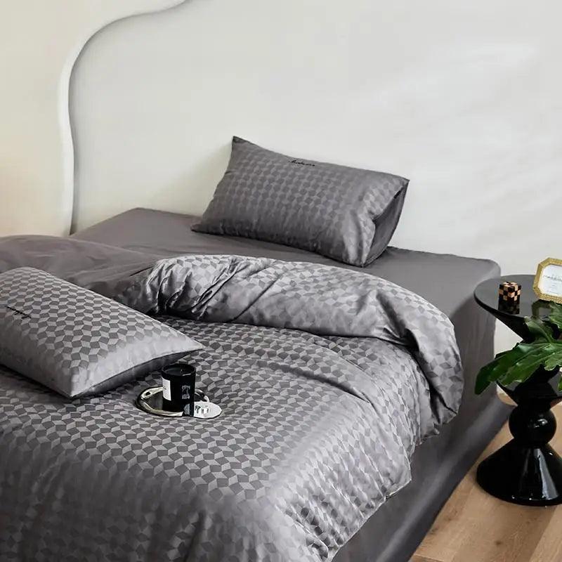 600TC Egyptian Cotton Diamond Wave Pattern Duvet Set in grey with a candle at the foot of the bed - Fluffyslip