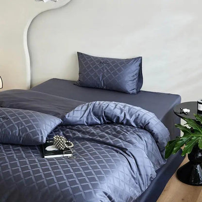 600TC Egyptian Cotton Diamond Wave Pattern Duvet Set in obsidian with a female jewelry at the foot of the bed on top of a coco chanel fashion magazine- Fluffyslip