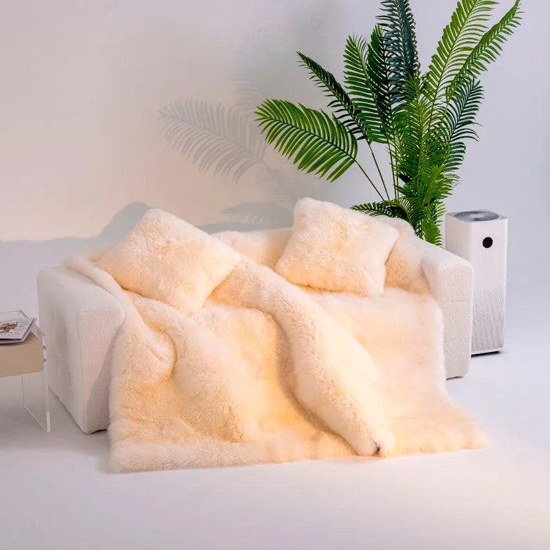Heavyweight Merino wool blanket displayed on a couch with two wool pillows