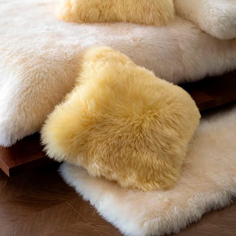 Yellow wool pillow resting alongside a white heavyweight merino wool blanket 