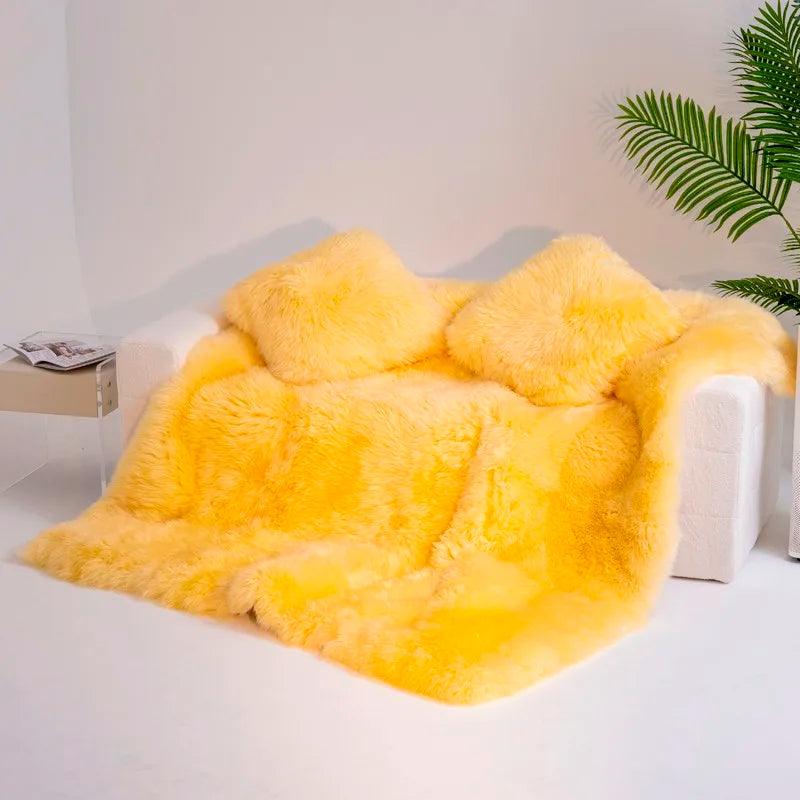 Yellow Heavyweight Merino Wool Blanket And two wool pillow shams on a couch