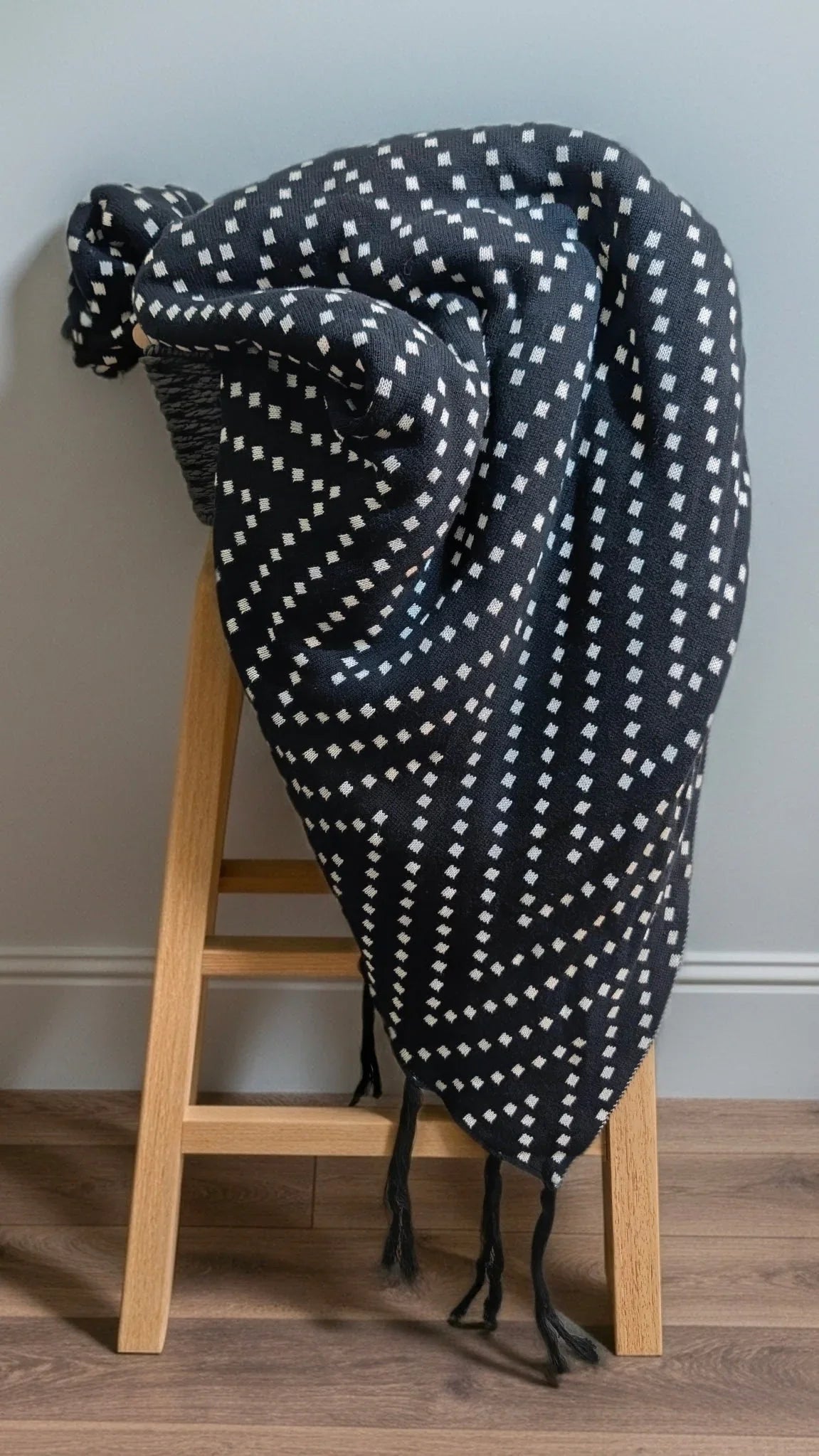 Polka dot blanket on a wooden stool